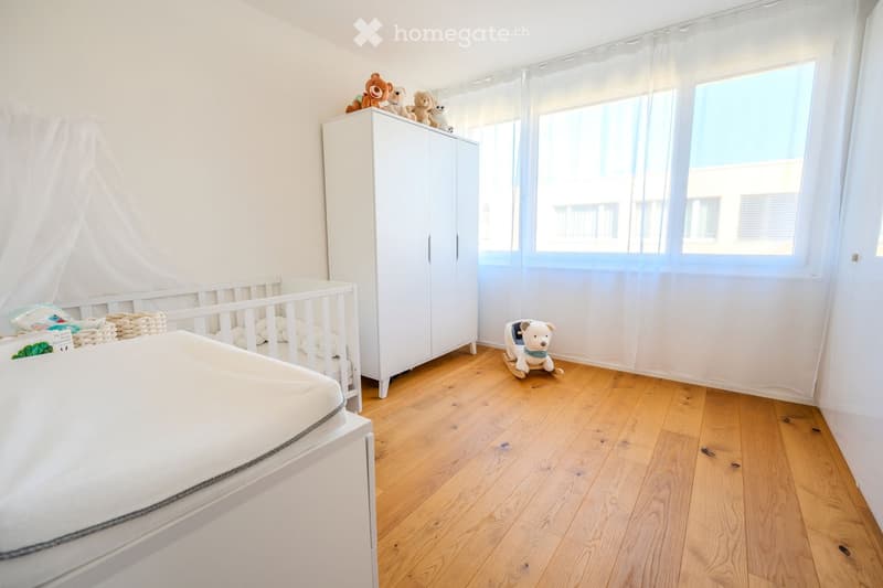 white walls, wooden floor, baby bed, wardrobe, stuffed toys, rocking teddy bear