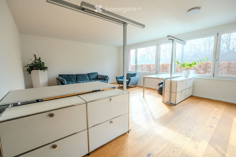 large windows with views, wooden floor, sofa, desk, chair, drawers