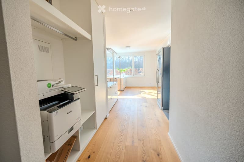 wooden floor, white walls, printer, refrigerator, cabinets, window