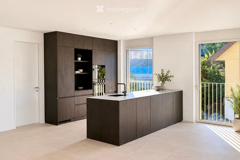Modern kitchen with dark wood cabinetry, a central island, and a sink, featuring a large window with a view of greenery outside.