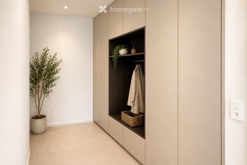 Modern hallway with built-in storage units, a potted plant, and a coat hanging on a hook.