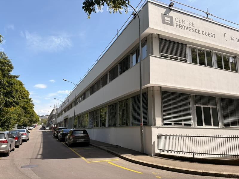 Modern two-story building with white facade, large windows, and signage reading "CENTRE PROVENCE OUEST".