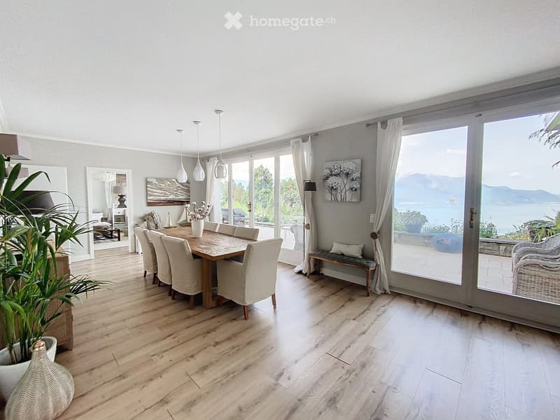 wooden floor, dining table, large windows, patio, ocean view