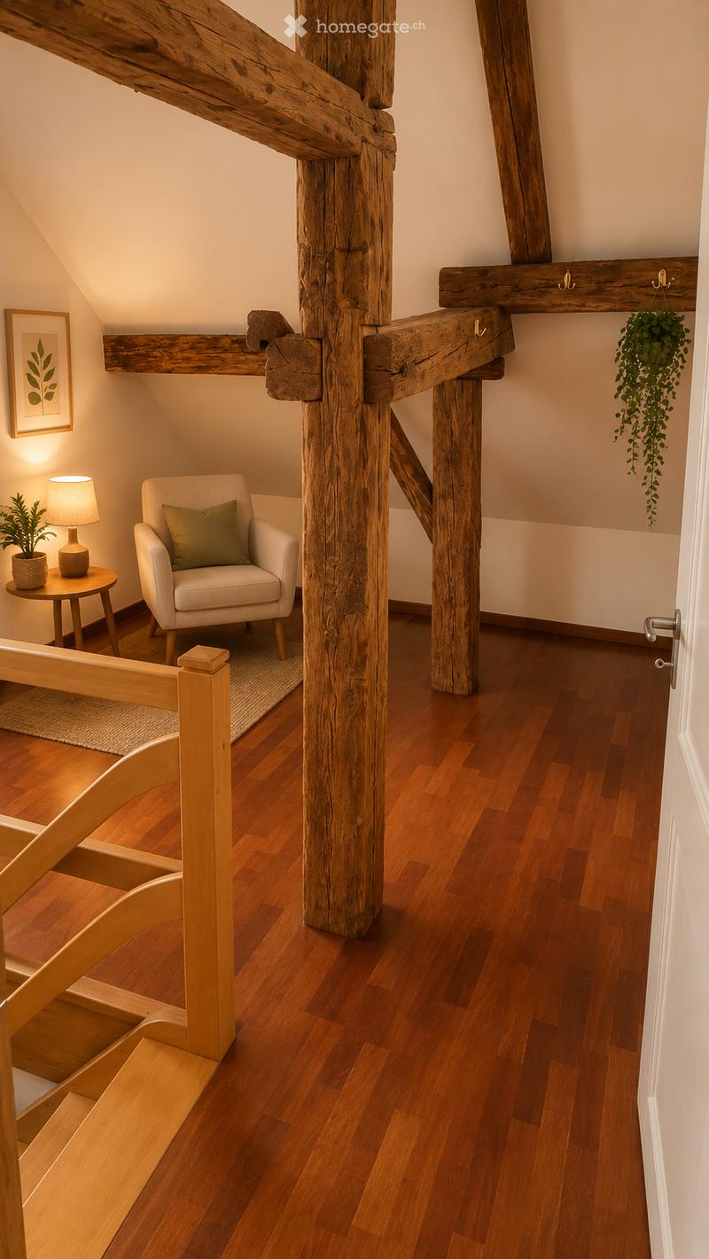 Cozy room with wooden floors, exposed wooden beams, a white armchair with green pillow, small round table with lamp and plant, and a hanging plant.