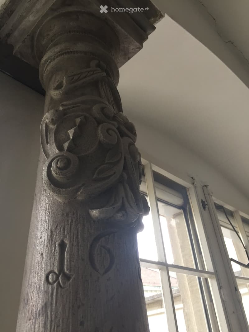 pillar with intricate carvings and a date mark on it