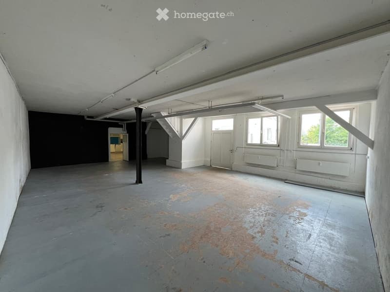 Empty room with bare walls, concrete floor, and visible structural beams. No furniture or equipment present.