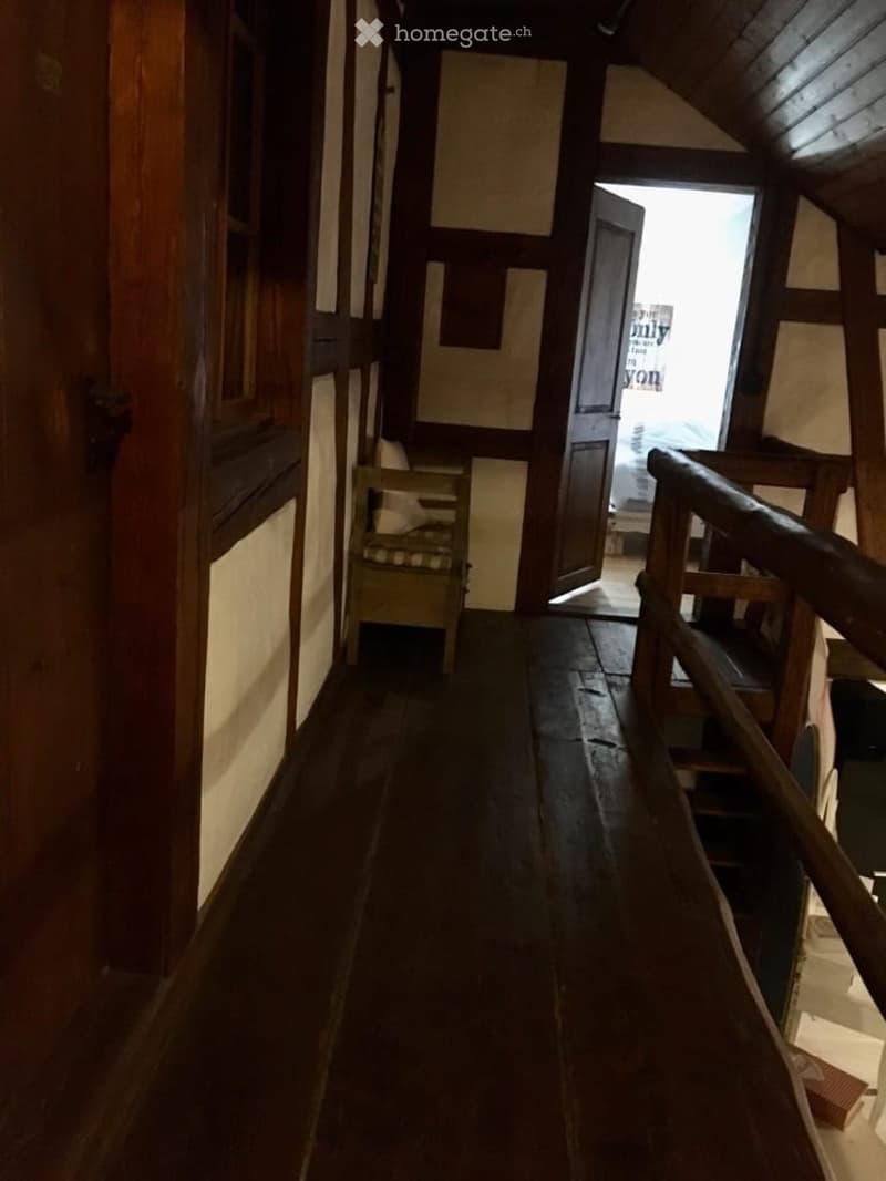 wooden floors, wooden railing, wooden beams on ceiling