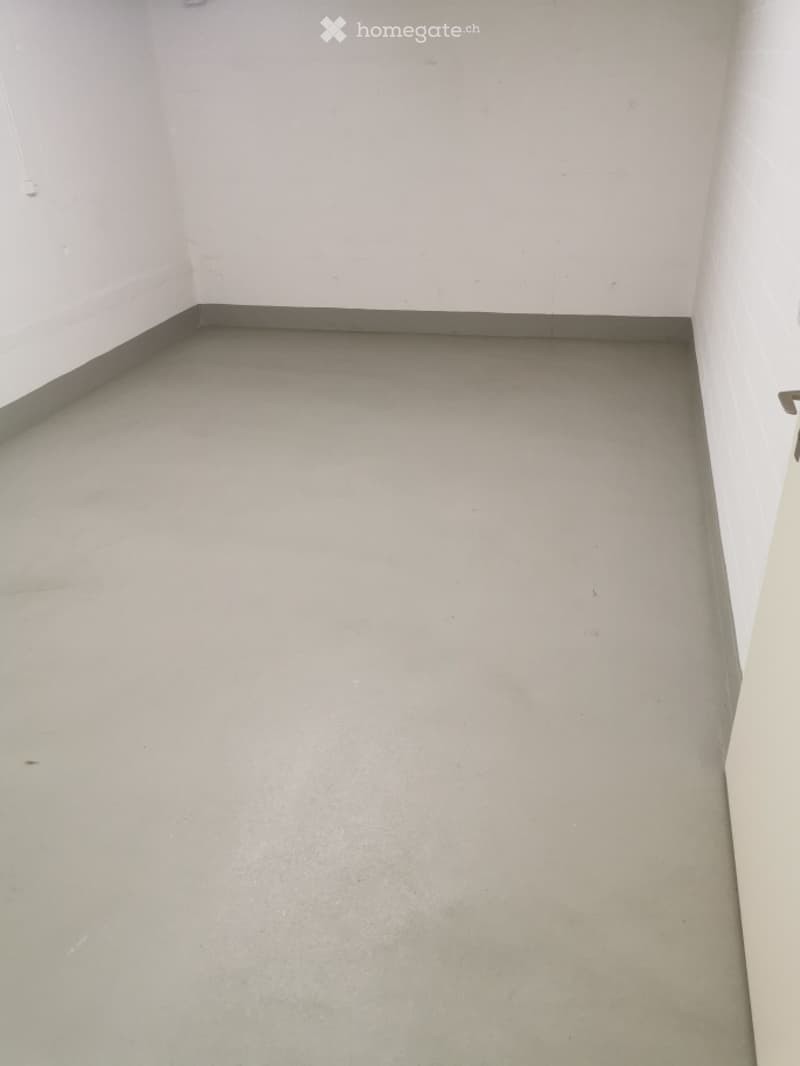 Completely empty room with bare walls and a smooth concrete floor. No furniture or equipment.