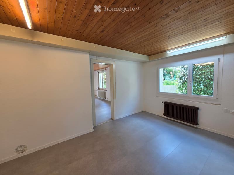 empty room, wooden ceiling, white walls, gray floor, window, radiator