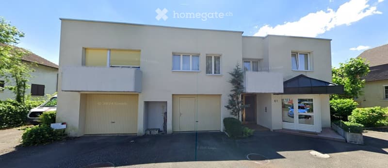 2 story building, beige exterior, windows, garages, entrance