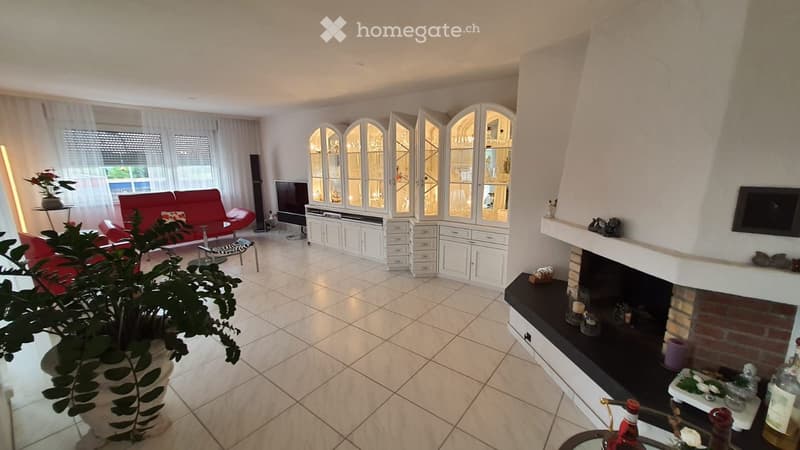 modern living room, white tile flooring, red leather sofa, center table, fireplace, TV, display cabinets, plant, television, glass door cabinet, brick fireplace