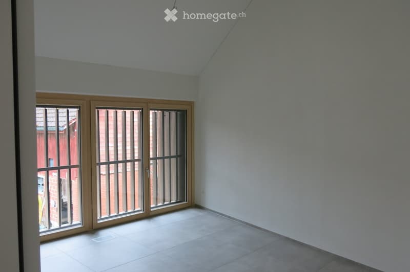 Unfurnished Room. Empty room with tiled floor, white walls, and large sliding glass doors with metal bars leading to an outdoor area.