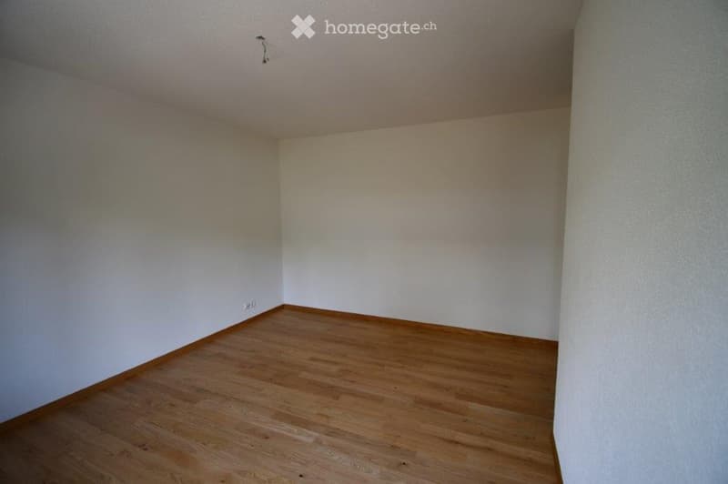 Empty room with wooden flooring and white walls, no furniture or equipment present.