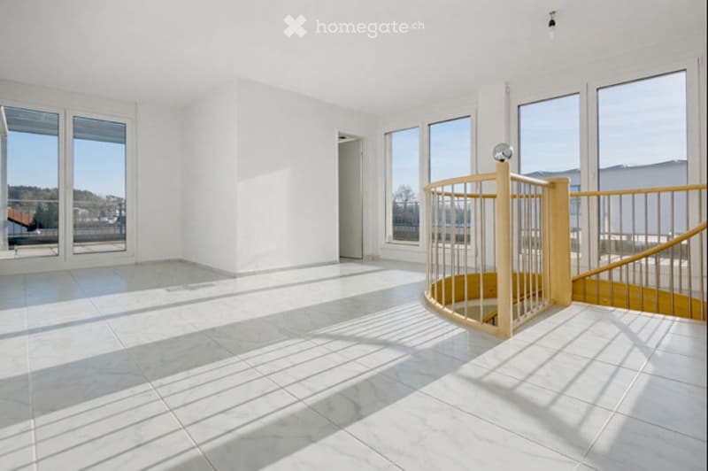 Open room with white marble flooring, spiral staircase, large windows