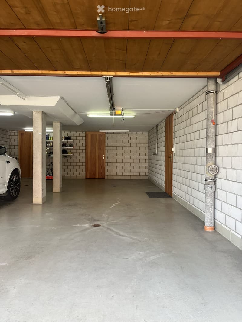 {"type": "Garage", "objects": ["car"], "description": "Underground garage with concrete floor, white tiled walls, wooden doors, and a parked white car.", "localized_descriptions": {"EN": "Underground garage with concrete floor, white tiled walls, wooden d