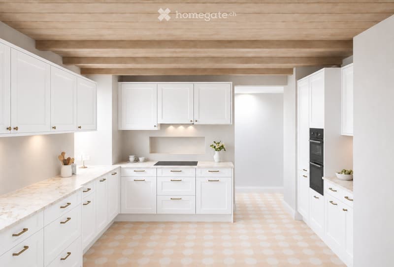 Modern kitchen with white cabinets, marble countertops, and a black oven. Features a vase with flowers and a bowl of fruit on the counter.