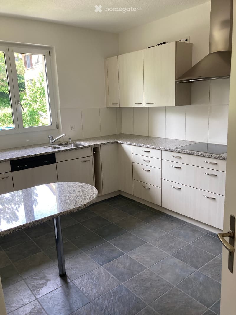 Kitchen. Modern kitchen with white cabinets, granite countertops, a sink with a faucet, a dishwasher, and a central island.