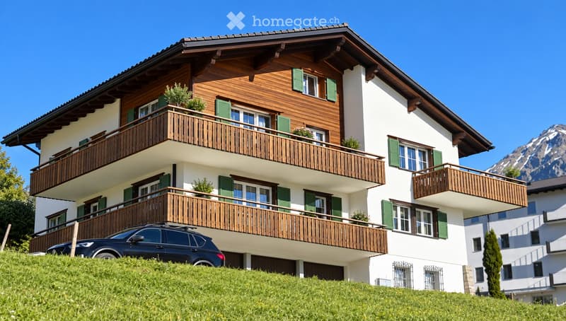 A two-story wooden house with white walls, green shutters, multiple balconies, and a view of mountains. A dark SUV is parked in the driveway.