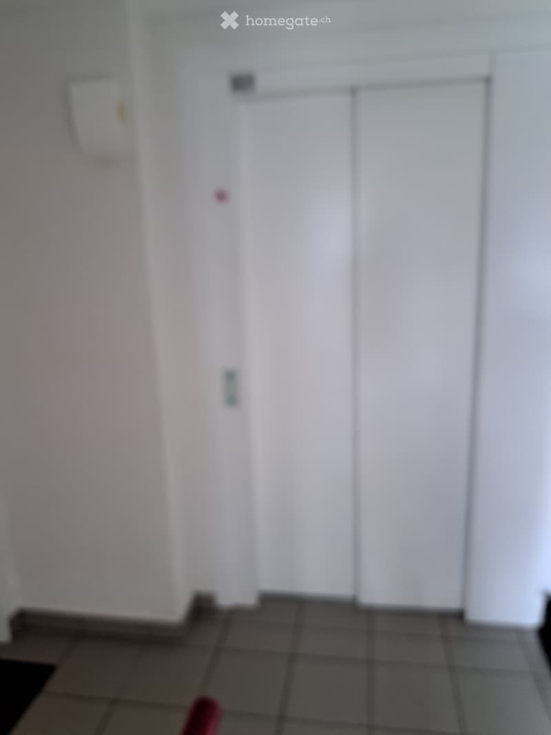 Empty room with tiled floor and white walls, no furniture or equipment visible.