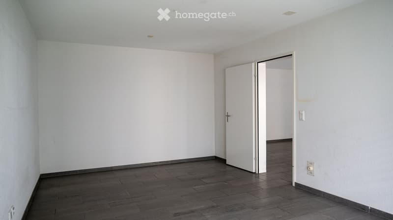 empty room, white walls, wooden floor, two doors