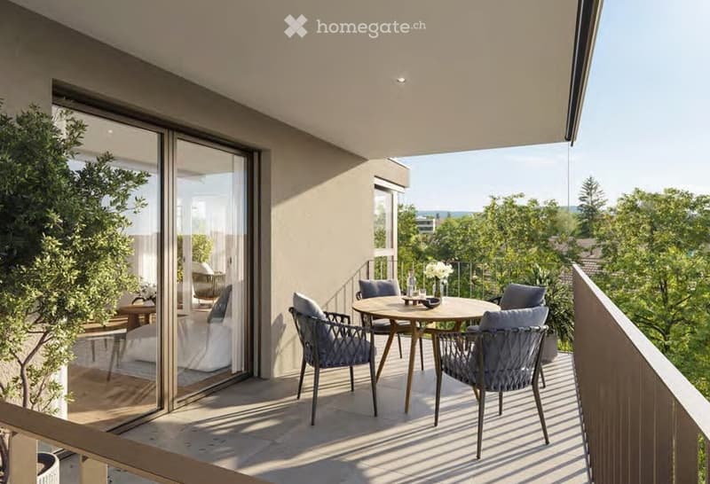 Balcony with a round wooden table and four wicker chairs, overlooking a green landscape.