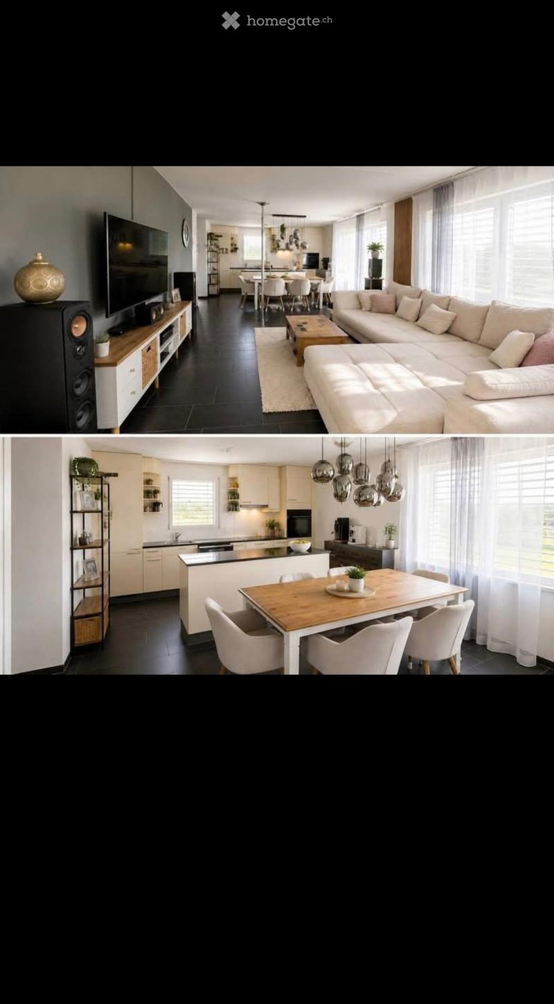 Modern open-plan living and dining area with a large sectional sofa, coffee table, TV stand with speakers, dining table with chairs, and a kitchen island with pendant lights.