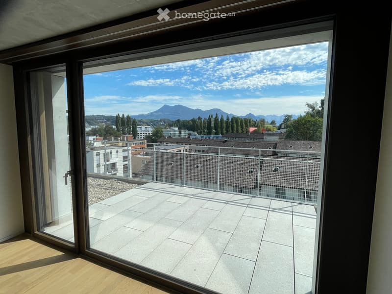 Balcony with tiled floor, metal railing, and scenic mountain view.