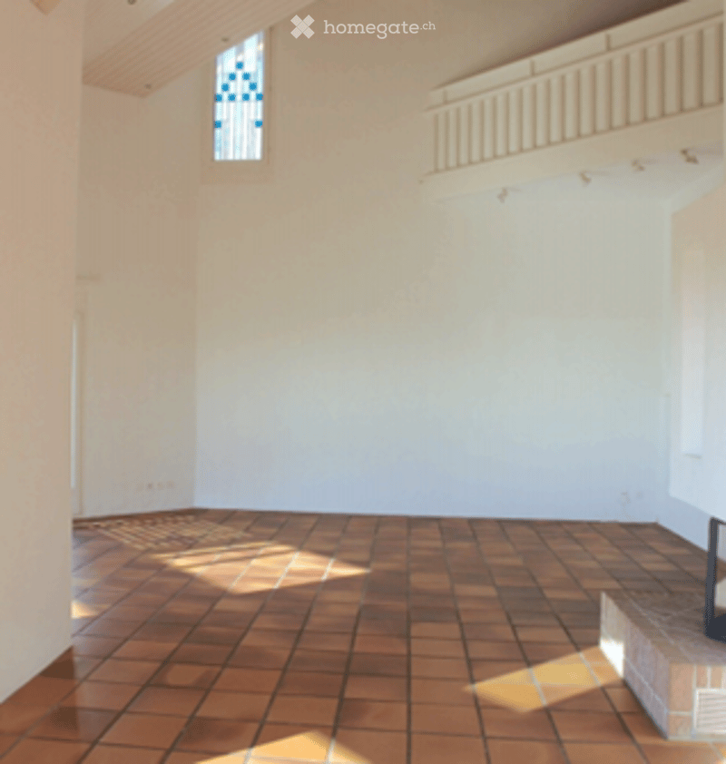 Empty room with white walls, wooden ceiling, and terracotta tiled floor. No furniture or equipment visible.