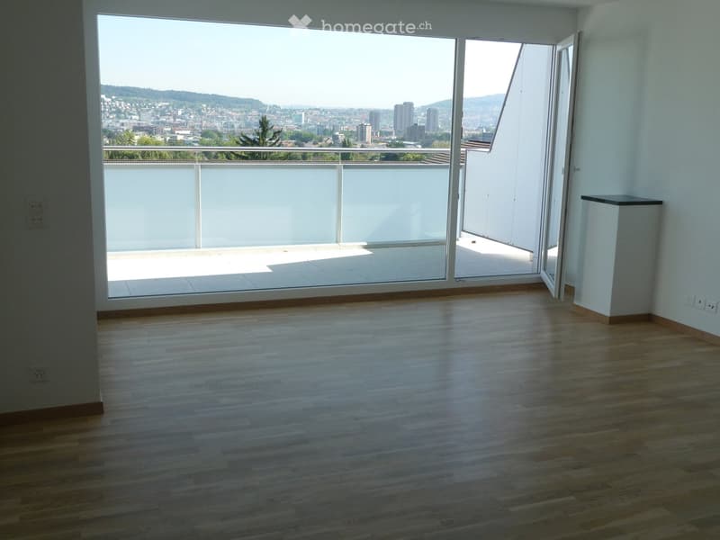 Empty room with wooden flooring, large glass doors leading to a balcony with a city view.