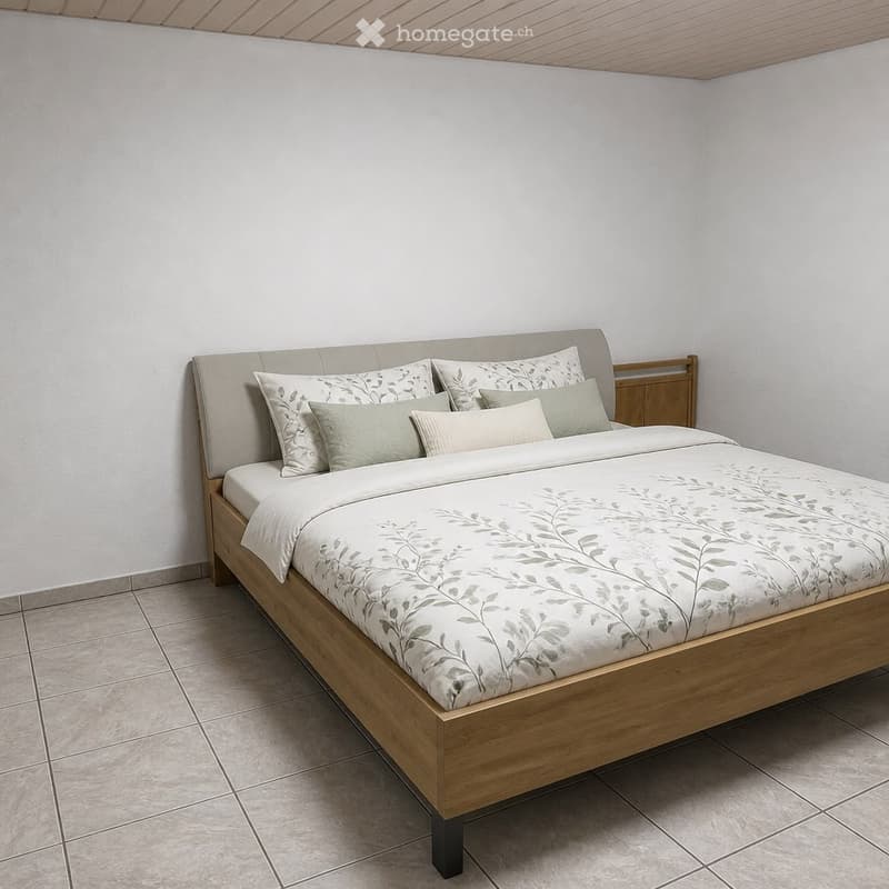 Modern bedroom with a wooden bed frame, a headboard, and multiple pillows. The bed is neatly made with a duvet and decorative pillows. A small wooden nightstand is visible next to the bed.