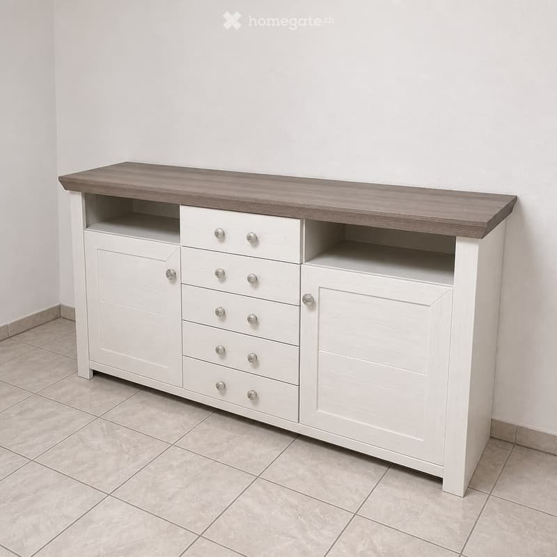 A white cabinet with a grey wooden top, featuring multiple drawers and cabinets, placed against a white wall on a tiled floor.