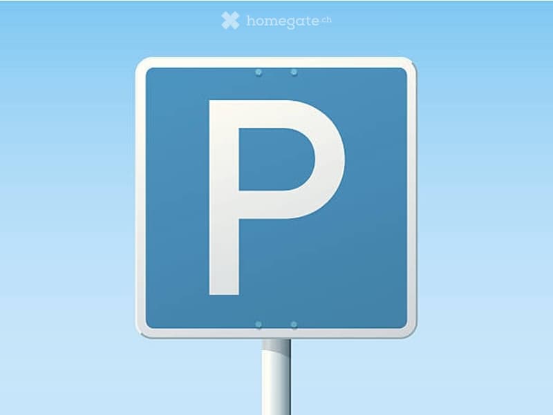 A parking sign with a white 'P' on a blue background, mounted on a pole against a clear blue sky.
