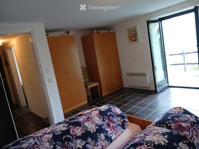 double bed, wardrobes, chair, door to another room, sliding door to outside