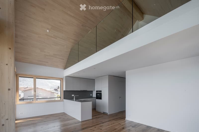 Modern kitchen with white cabinets, wooden ceiling, and large window overlooking a residential area.