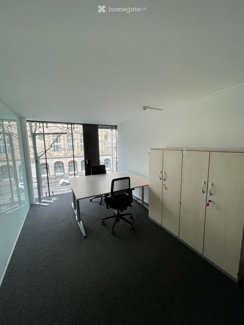 large window with city view, white walls, desk with chairs, cupboards, carpet floor