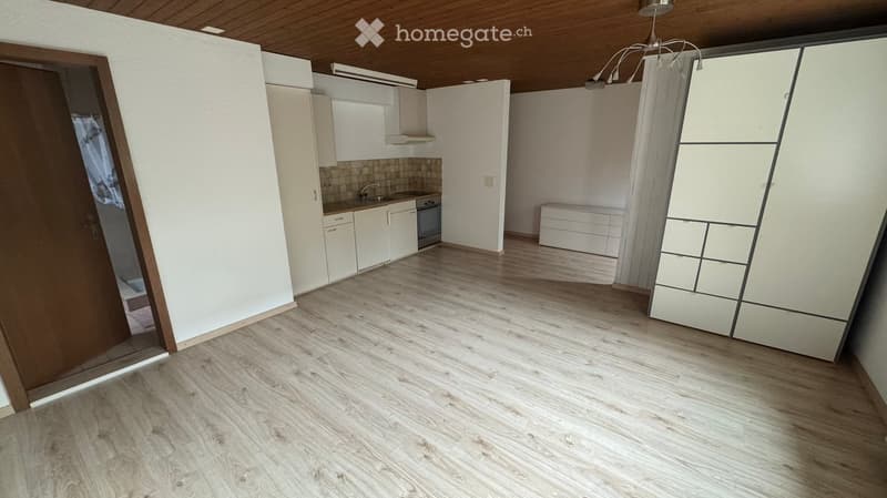 empty kitchen with sink and dishwasher, cabinets, tiled wall, and sliding door