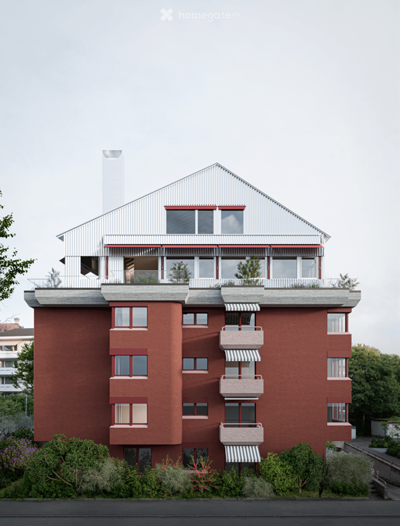 Modern multi-story building with red brick facade, white trim, multiple balconies, and a rooftop terrace with greenery.