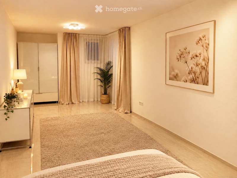 Modern bedroom with a bed, a large wardrobe, a side table with a lamp, a potted plant, and a large picture frame on the wall.