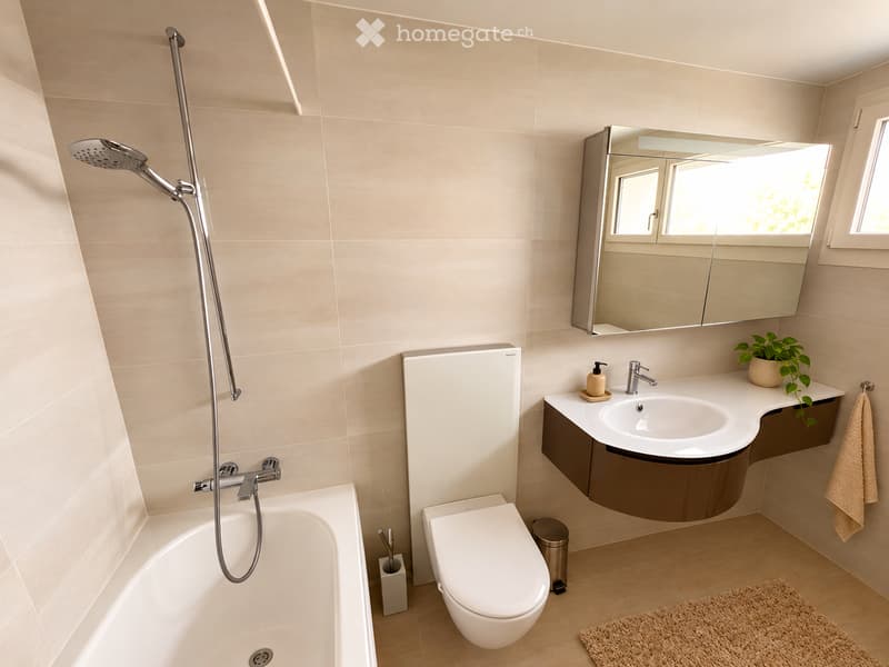 Modern bathroom with beige tiles, a bathtub, toilet, sink with a mirror, and a showerhead. Includes a small plant on the sink counter and a towel hanging on the side.