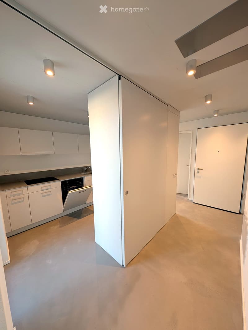 Modern kitchen with white cabinets, a sink, a faucet, and a dishwasher. The space is clean and well-lit with recessed lighting.