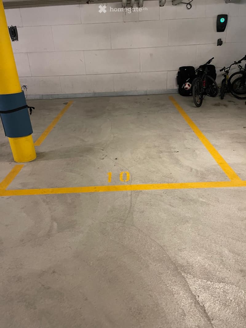 Underground parking area, yellow parking lines, numbered parking space