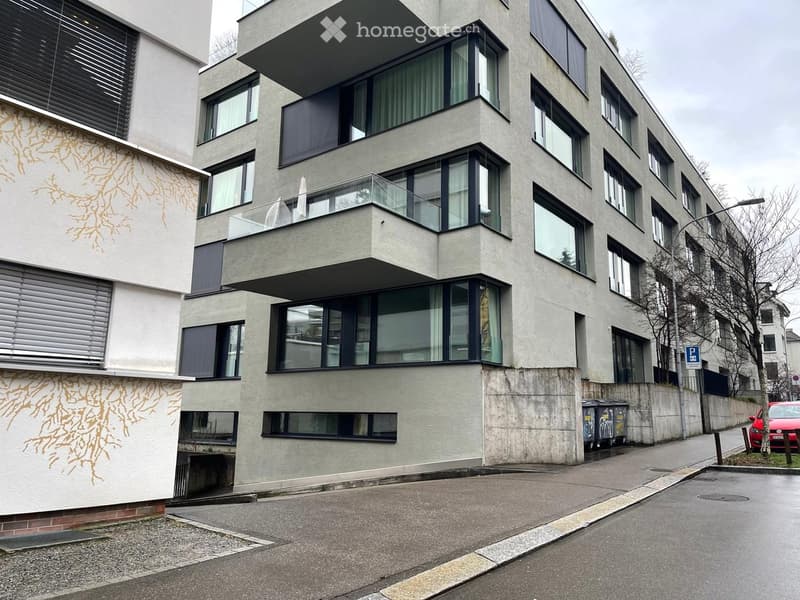 modern apartment building, balconies on multiple floors, large windows, entrance