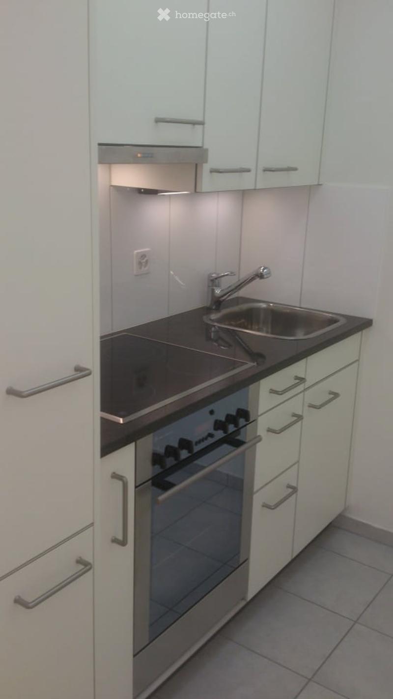 modern kitchen, white cabinets, stainless steel appliances, gas stove, oven, sink, faucet, power outlet