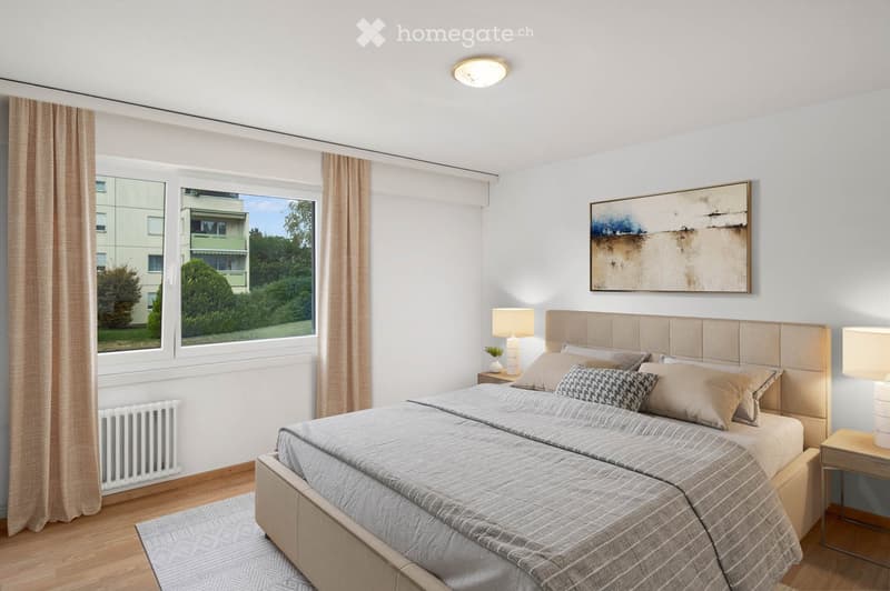 Modern bedroom with a large bed, nightstands, lamps, and a large window with curtains. The room features a painting on the wall and a radiator below the window.