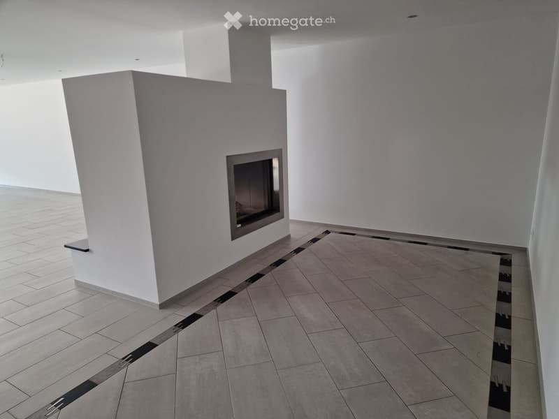 Empty room with white walls, tiled floor, and a built-in fireplace.