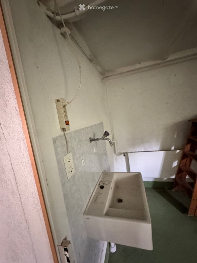 Small bathroom, a sink, shower head, power outlet, power strip