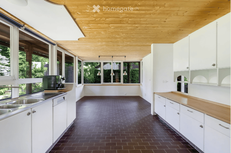 modern kitchen with large windows, wooden ceiling, stainless steel kitchen appliances, dishwasher, granite countertop