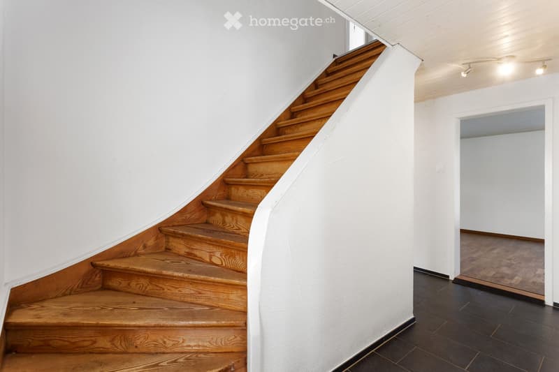 wooden staircase, white walls, wooden floor, white ceiling, open door