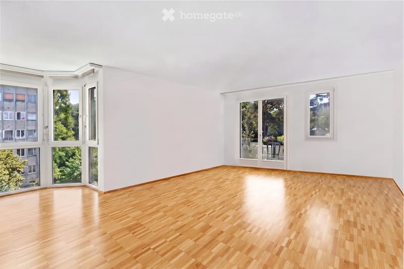 Completely empty room with bare white walls and wooden floor. No furniture or equipment.