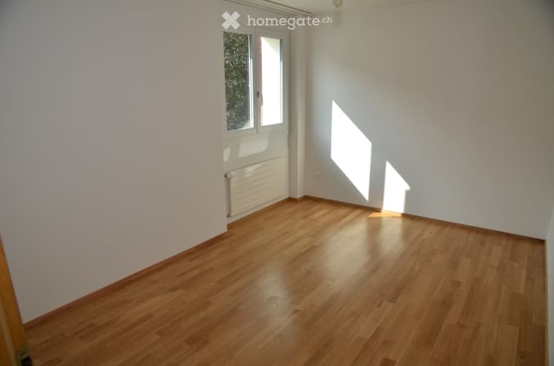 Completely empty room with bare white walls and wooden floor. No furniture or equipment.